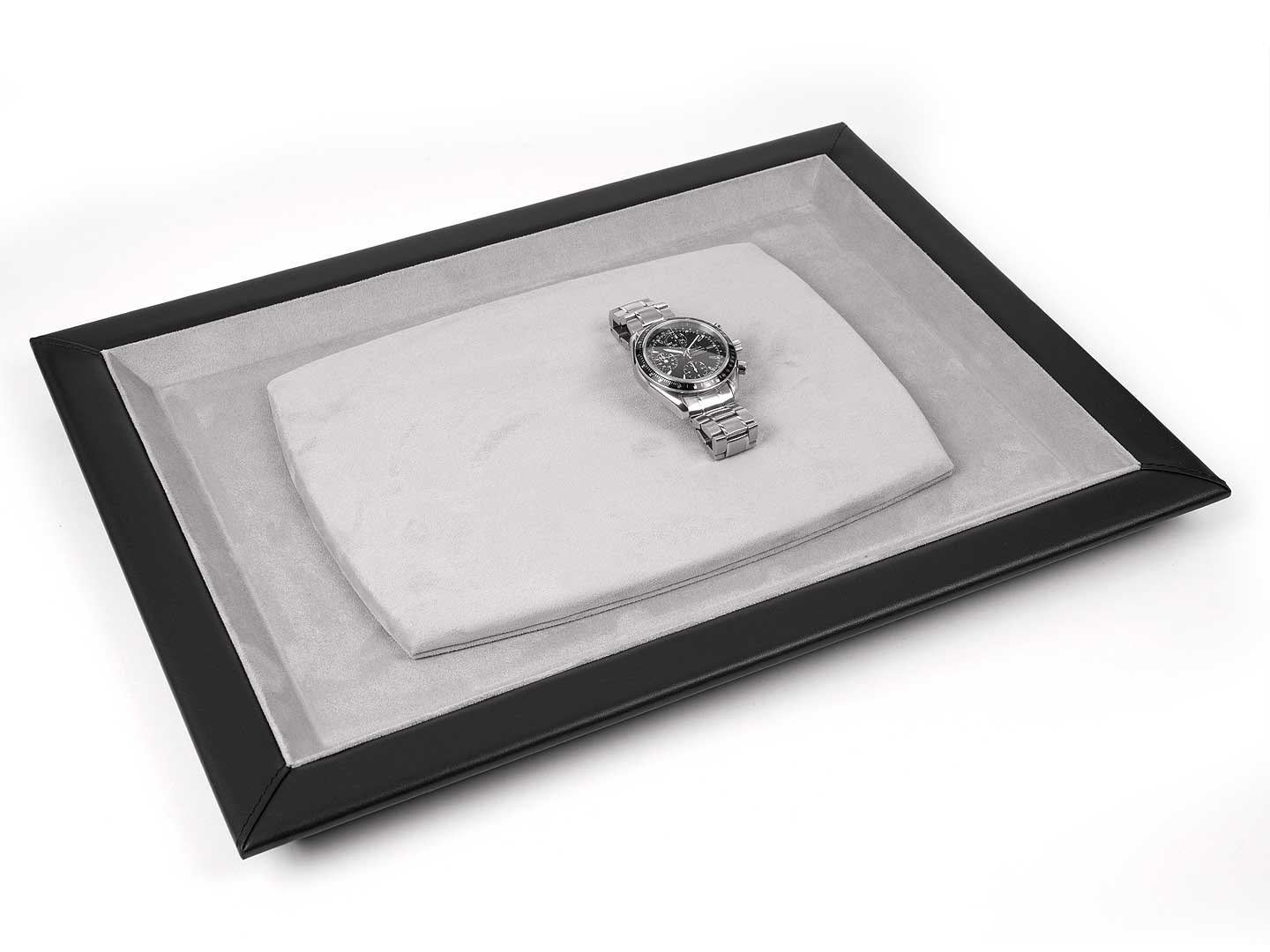 Black leather watch tray with gray interior and a steel watch