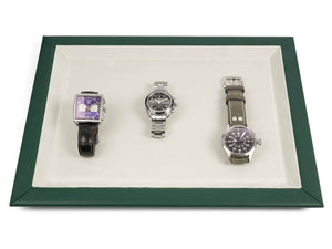 Green leather watch presentation tray with beige interior and 3 watches on it 